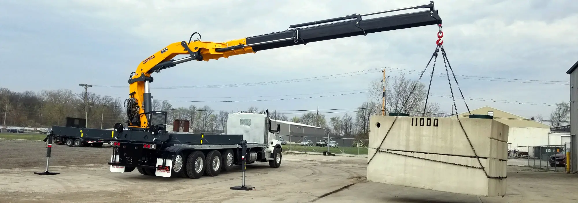 book truck loading a concrete septic tank